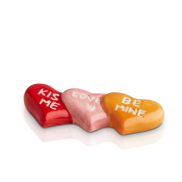 Nora Fleming it's a love thing Mini ceramic attachment featuring a pink heart design with sweet saying—perfect for Valentine’s Day décor. Available at Be Charmed.