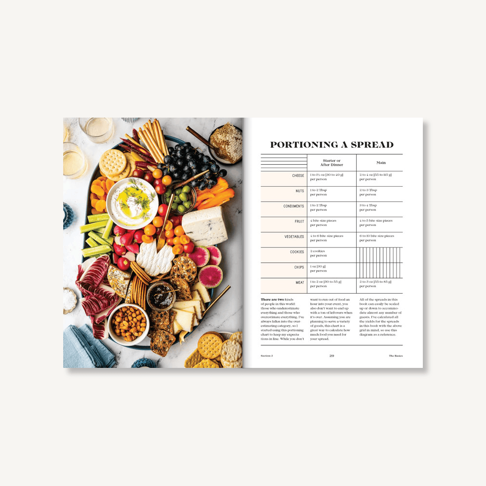 Opened page of ables & Spreads book by Chronicle Books – entertaining guide by Shelly Westerhausen Worcel with creative ideas for grazing boards, snack spreads, and seasonal tablescapes, perfect for hosts and food lovers, available at Be Charmed.