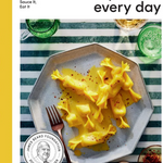 Book cover of 'Pasta Every Day' with a plate of pasta and a glass of green drink on a striped background. Available at Be Charmed