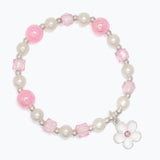 Bracelet with pink and white beads and a flower charm on a white background. Available at Be Charmed