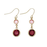 Periwinkle burgundy and pink crystal dangle earrings featuring vibrant faceted stones in a polished setting, available at Be Charmed