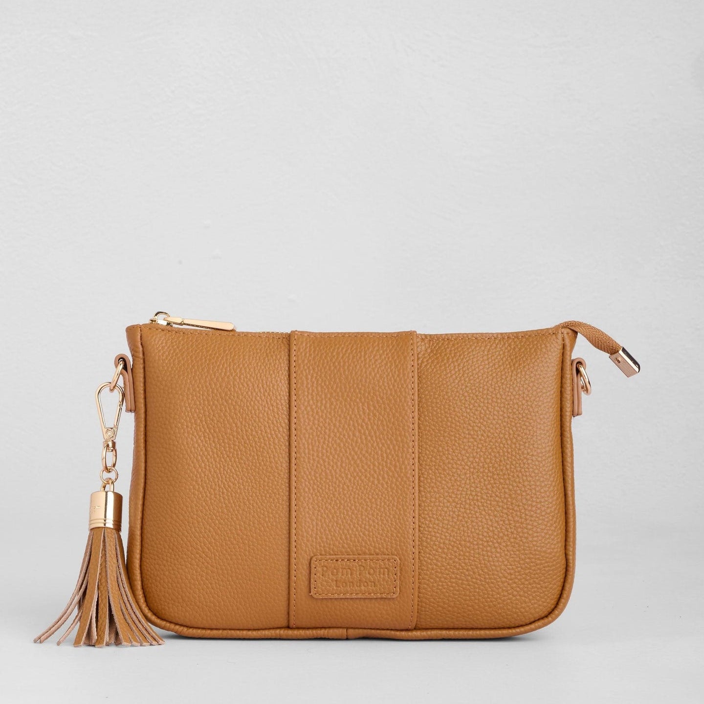 Maple Pom Pom London City Slim Bag – handcrafted leather crossbody with sleek design and adjustable strap. Designed in London. Available at Be Charmed.