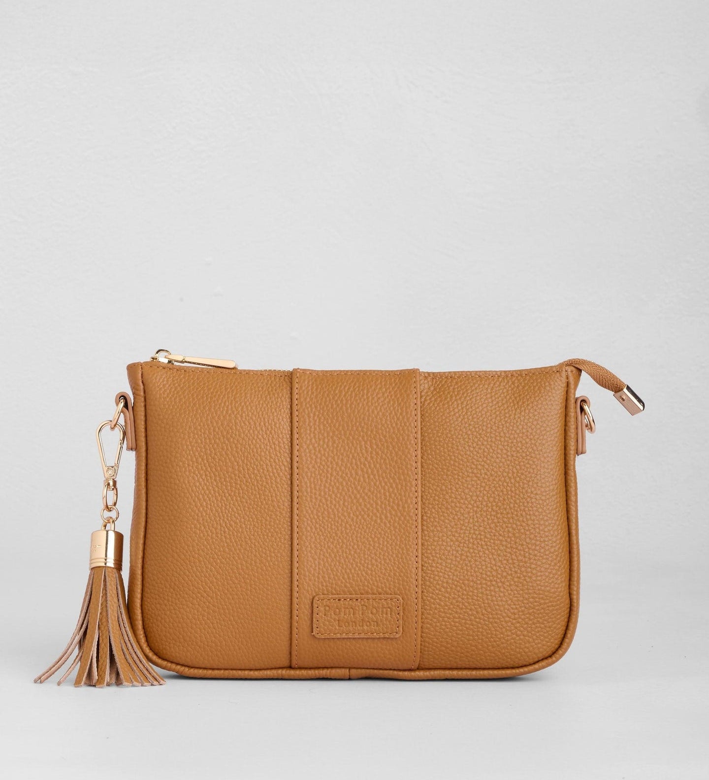 Maple Pom Pom London City Slim Bag – handcrafted leather crossbody with sleek design and adjustable strap. Designed in London. Available at Be Charmed.
