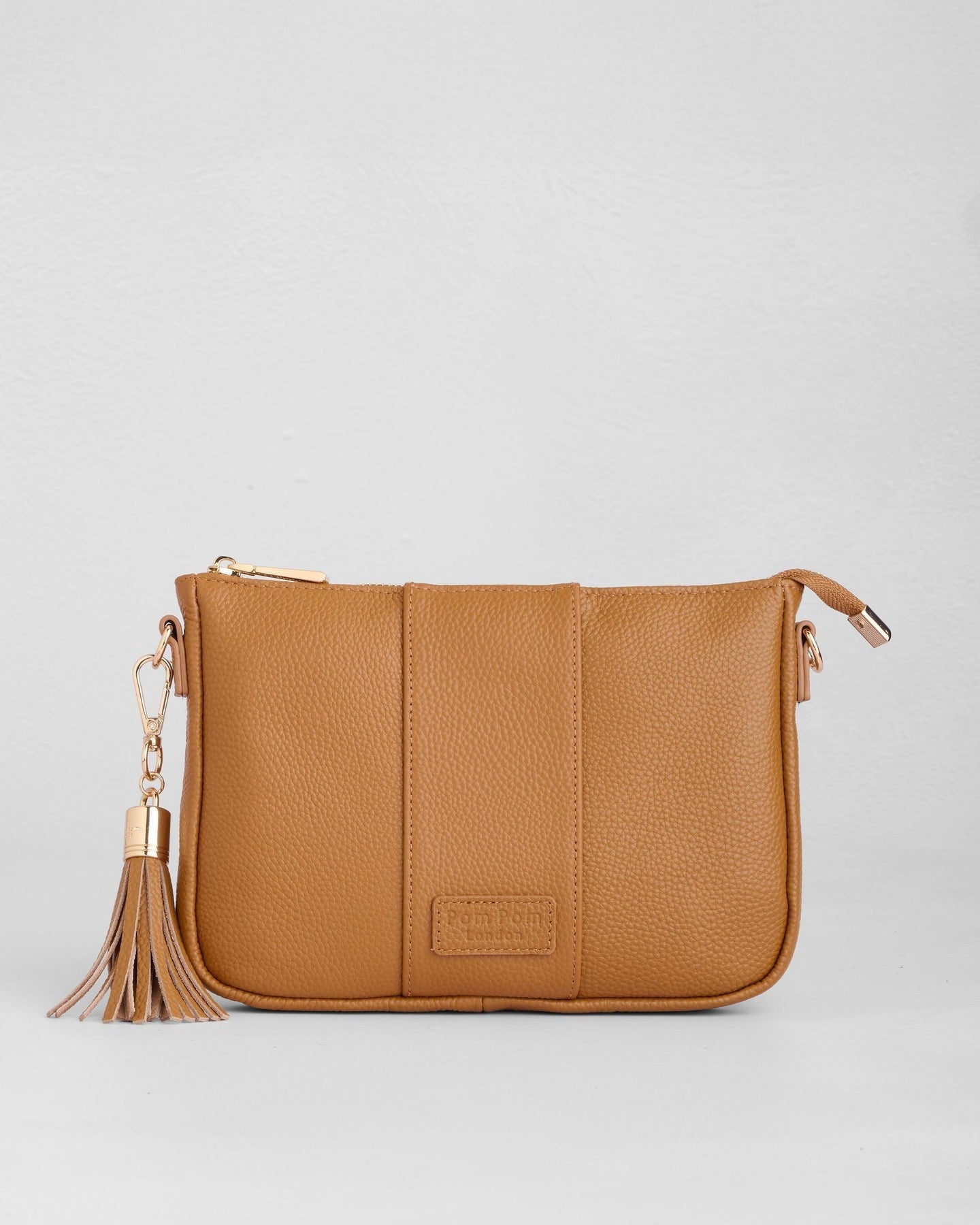 Maple Pom Pom London City Slim Bag – handcrafted leather crossbody with sleek design and adjustable strap. Designed in London. Available at Be Charmed.