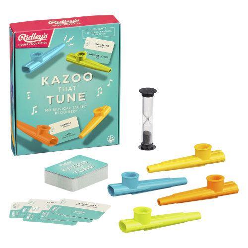 Ridley's Kazoo That Tune toy set on a white background, showing the retail box, several colorful kazoo instruments in blue, yellow, orange, and green, a small sand timer, and cards. Available at Be Charmed