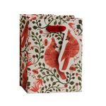 A Rifle Paprer Co gift bag with a cream background, featuring a red cardinal and green floral pattern, with red paper handles. Available at Be Charmed