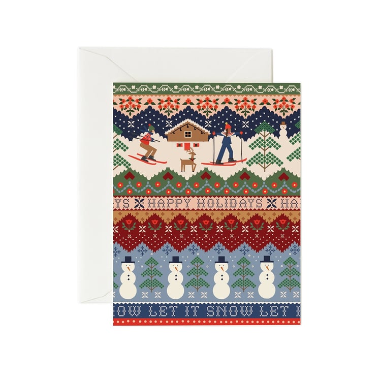 Rifle Paper Co Christmas-themed greeting card with skiing design and envelope on a white background. Available at Be Charmed