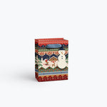 Rifle Paper Co. Ski Chalet gift bag featuring a whimsical illustration of a cozy mountain cabin, available at Be Charmed