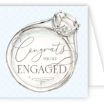 Card with an illustration of a diamond ring and 'Congrats, you're engaged' text on a light blue background. Available at Be Charmed
