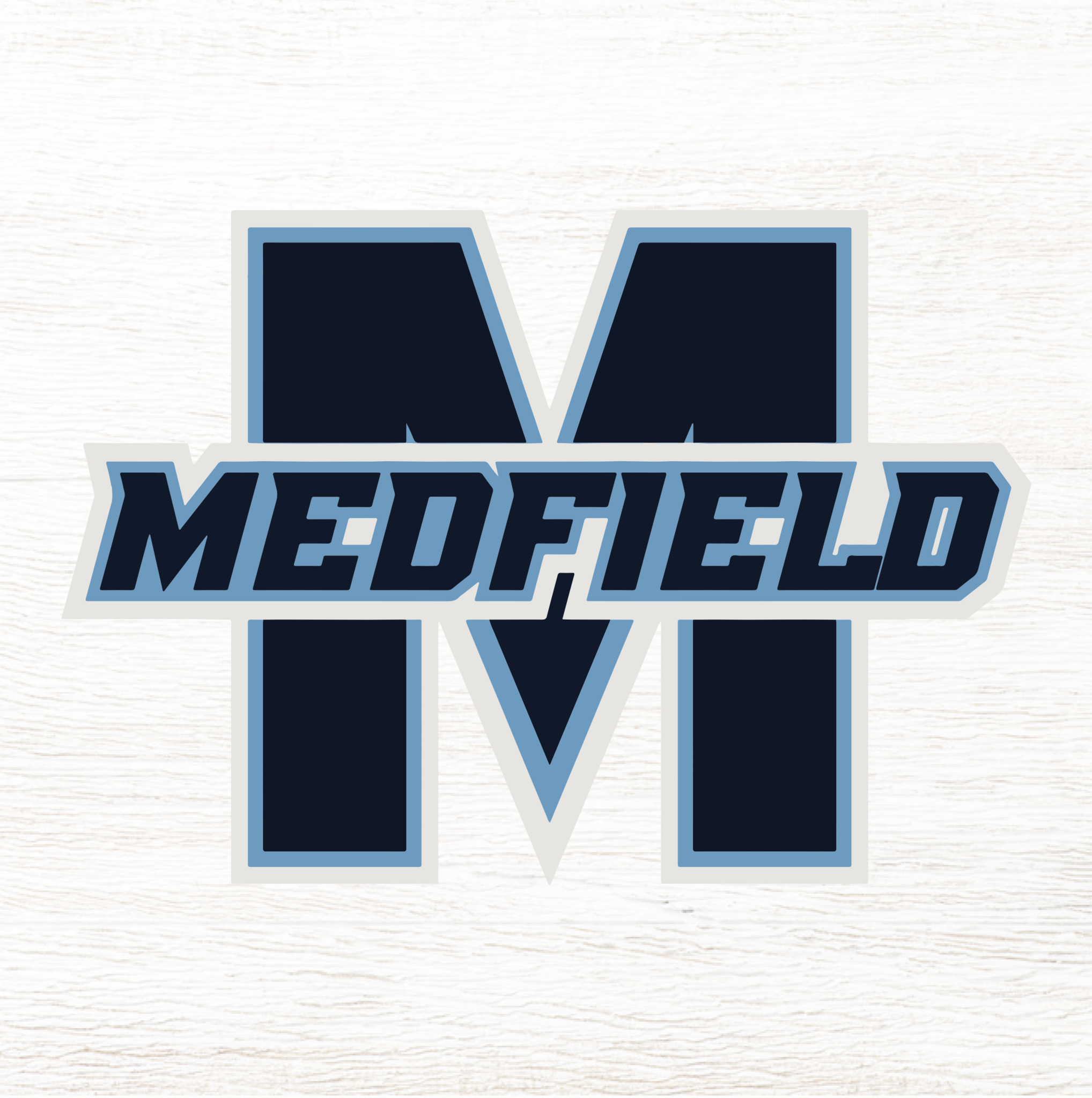 A decorative wood block with the letter 'M' in blue and the word 'MEDFIELD' in capital letters below the 'M'. Available at Be Charmed