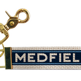 Keychain with 'MEDFIELD' colors and branding on a white background. Available at Be Charmed