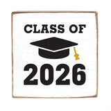 Decorative block with 'Class of 2026' text and a graduation cap design on a white background. Available at Be Charmed