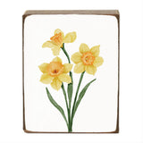 Decorative block with yellow daffodil flowers on a white background. Available at Be Charmed