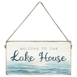 Decorative sign with 'Welcome to our Lake House' text and water design. Available at Be Charmed