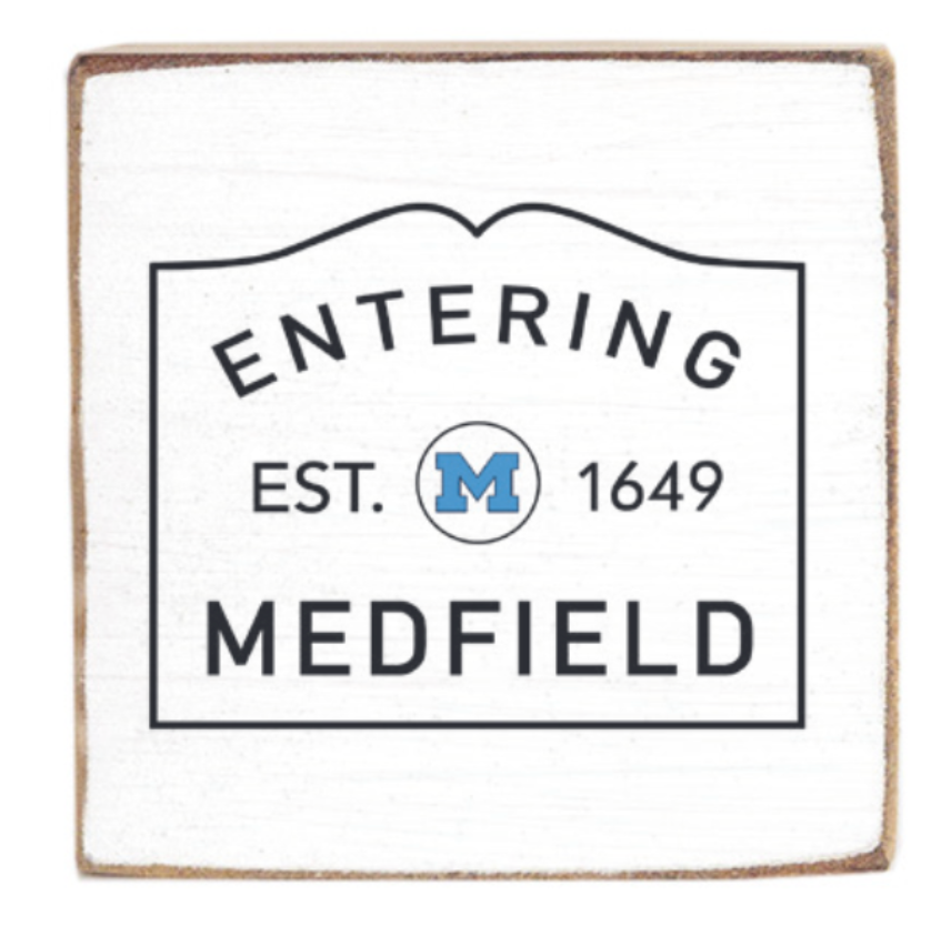 Rustic Marlin magnet with 'Entering Medfield' text and a blue 'M' on a white background. Available at Be Charmed