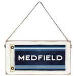 Rectangular twine sign with 'MEDFIELD' text on a blue background, hanging by a string. Available at Be Charmed