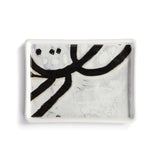 ArtLifting Mini Tray featuring bold black and white abstract artwork on durable stoneware; ideal for jewelry, keys, or décor. A meaningful gift supporting artists from underrepresented communities. Dishwasher and microwave safe. Available at Be Charmed