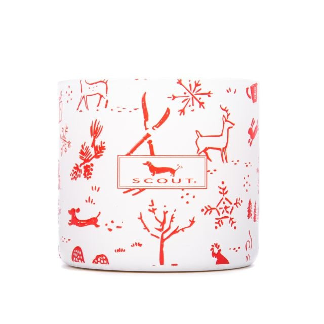 A white candle with red animal patterns including a deer and a dog, and the brand 'Scout' visible on the lid. Available at Be Charmed