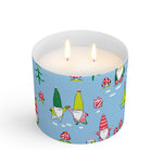 A Scout candle with a blue label featuring whimsical gnome illustrations. Available at Be Charmed