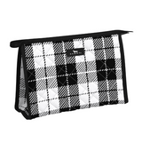 A black and white checkered cosmetic or makeup bag with a small finger loop and a brand tag visible on the side. Available at Be Charmed