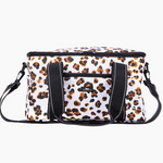 A white insulated cooler bag with a brown and black leopard print pattern, featuring black webbing handles and a matching shoulder strap, shown against a plain white background. Available at Be Charmed