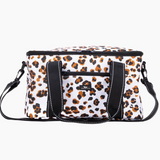 A white insulated cooler bag with a brown and black leopard print pattern, featuring black webbing handles and a matching shoulder strap, shown against a plain white background. Available at Be Charmed