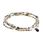 Bracelet/Necklace with black and beige beads on a white background. Available at Be Charmed