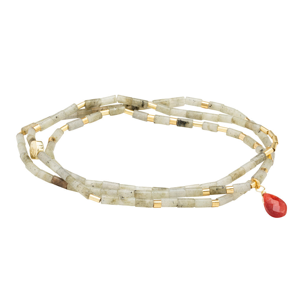 Beaded bracelet/necklace with a red pendant on a white background. Available at Be Charmed