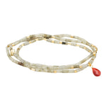 Beaded bracelet/necklace with a red pendant on a white background. Available at Be Charmed