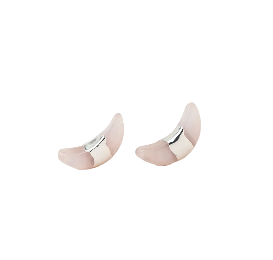 Pair of silver and rose crescent moon earrings on a white background. Available at Be Charmed