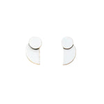 A pair of silver crescent earrings with a minimalistic design on a white background. Available at Be Charmed
