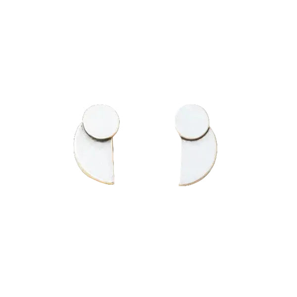 A pair of silver crescent earrings with a minimalistic design on a white background. Available at Be Charmed