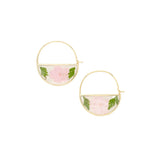 Gold hoop earrings with pink floral elements on a beige background