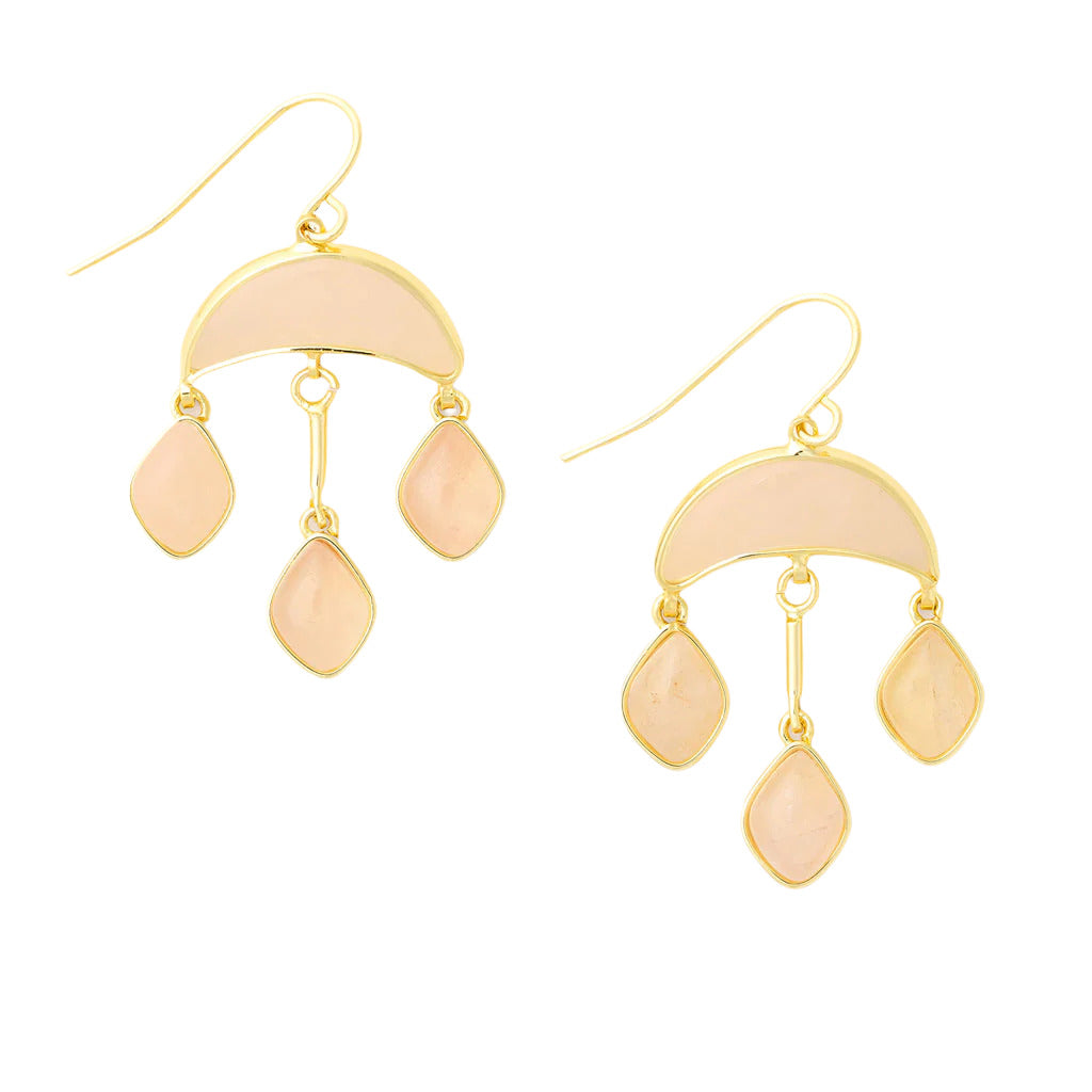 A pair of gold-colored crescent-shaped earrings with pink stone accents, suspended from hooks. Available at Be Charmed