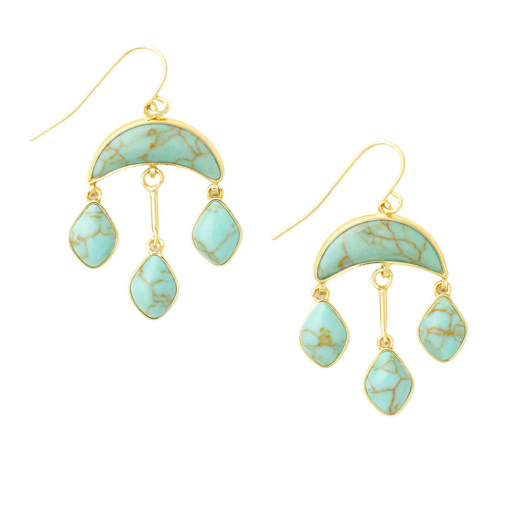 A pair of gold-colored crescent-shaped earrings with blue stone accents, suspended from hooks. Available at Be Charmed