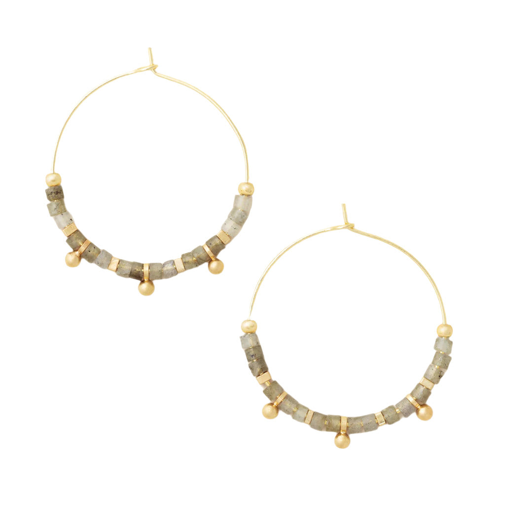 A pair of hoop earrings with earth tone stone discs and gold accents, arranged in a hoop shape. Available at Be Charmed