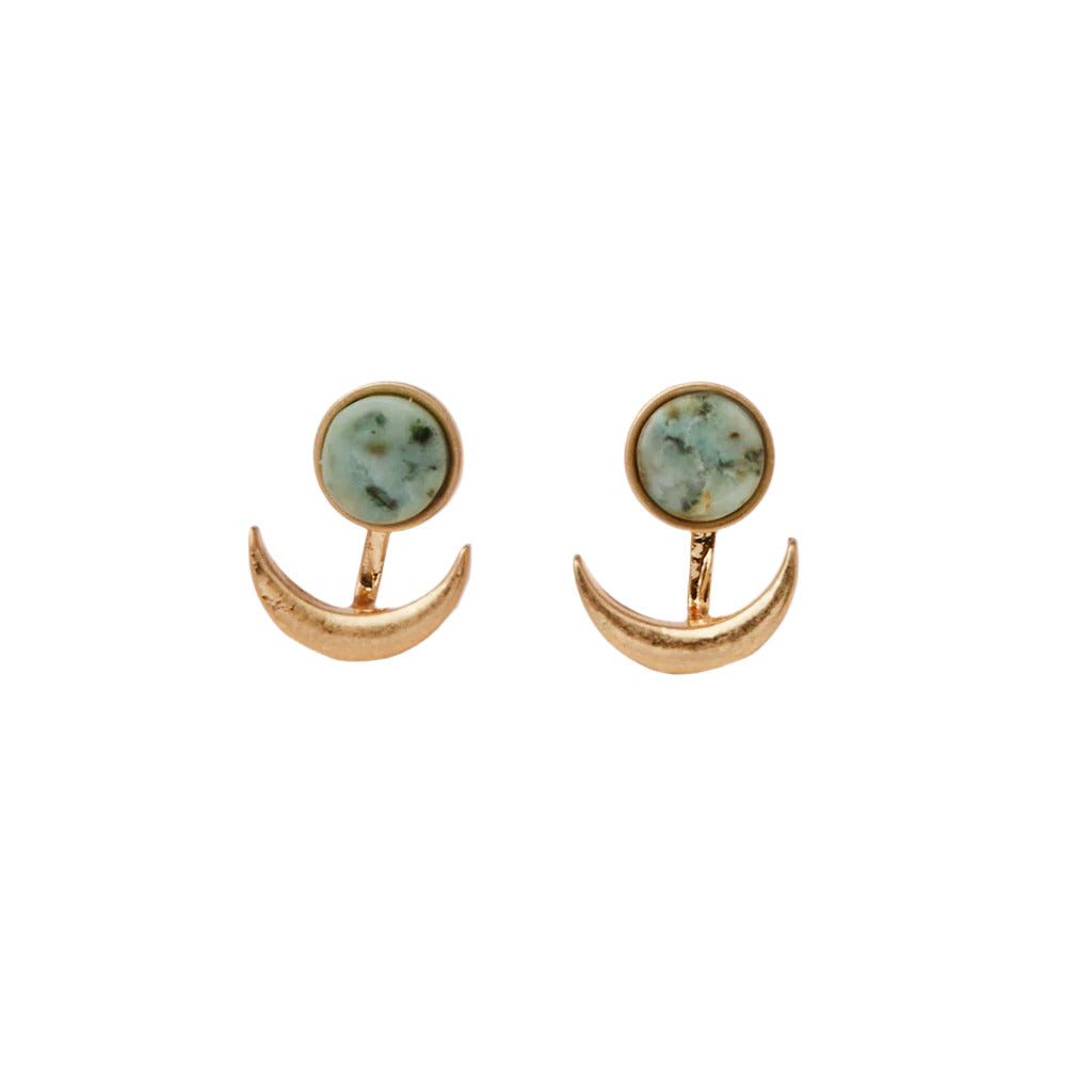 A pair of earrings featuring a crescent moon design with a stone in the center, attached to a gold-colored backing. Available at Be Charmed