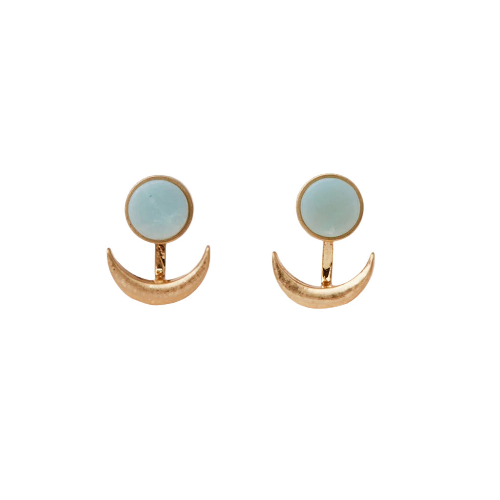 A pair of earrings featuring a crescent moon design with a stone in the center, attached to a gold-colored backing. Available at Be CHamred