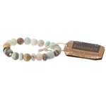 A earthtone stone stacking bracelet with a label tagged 'stone of courage'. Available at Be Chamred