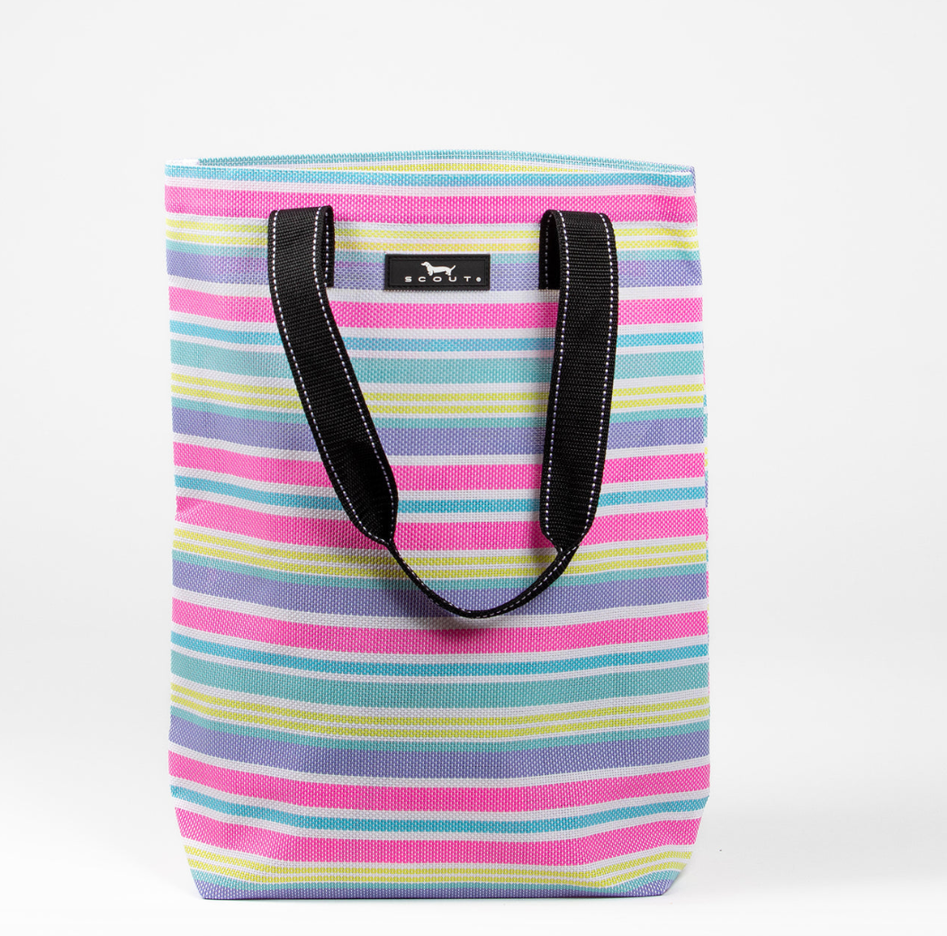 A multicolored striped Scout tote bag with black straps and a black logo label. Available at Be Charmed