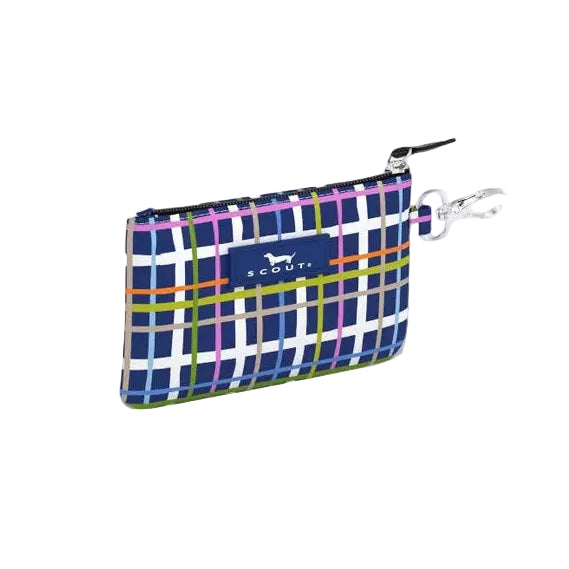 A small zippered Scout pouch with a blue, purple, and white plaid pattern and a yellow stripe, shown on a plain light gray background. Available at Be Charmed