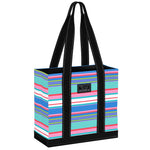 A striped multicolored Scout tote bag with black straps and a black brand logo on the front. Available at Be Charmed