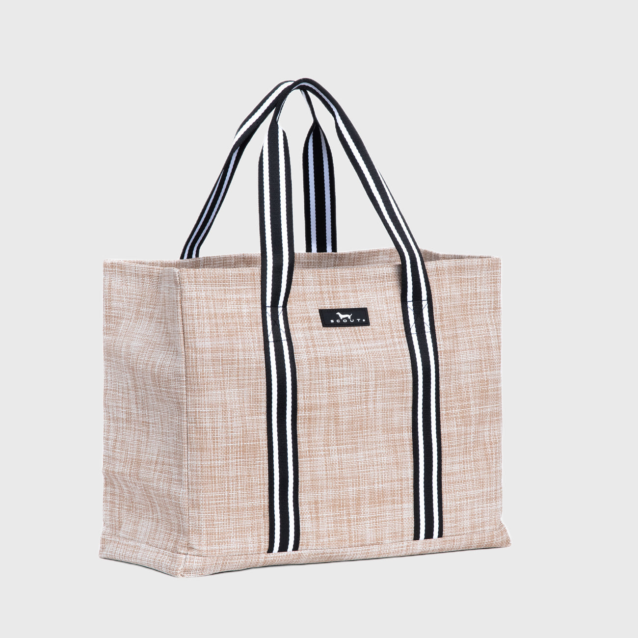 Sand woven Scout tote bag with black and white striped handles on a light gray background. Available at Be Charmed
