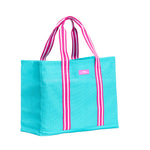 Turquoise tote bag with pink and white striped handles on a white background. Available at Be Charmed.