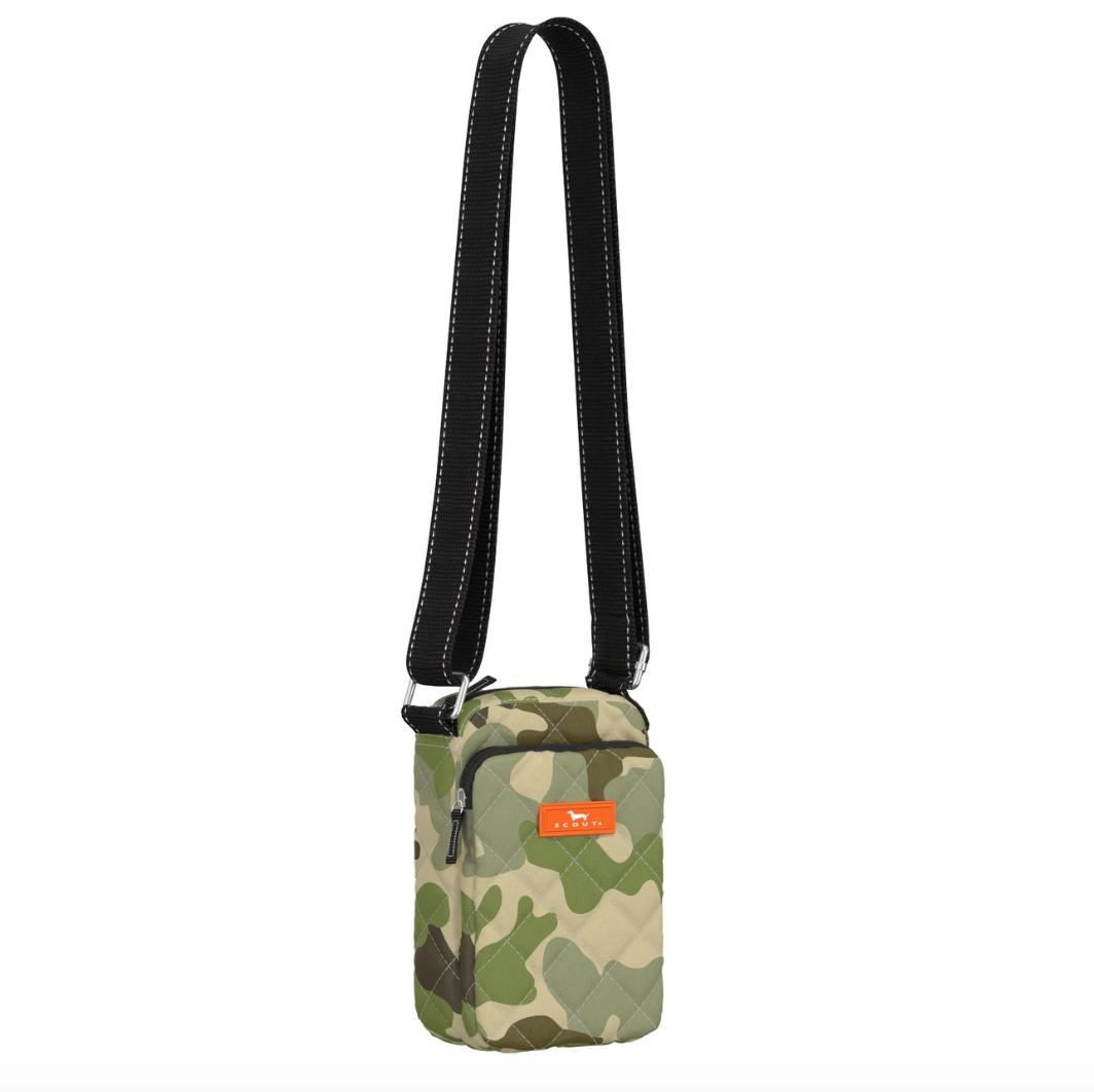 A camouflage quilted Scout crossbody bag with black straps, displayed against a white background. Available at Be Charmed
