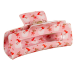 Holly Jolly Santa Pink hair clip with a santa and floral pattern on a white background. Available at Be Charmed. 