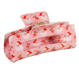 Holly Jolly Santa Pink hair clip with a santa and floral pattern on a white background. Available at Be Charmed. 