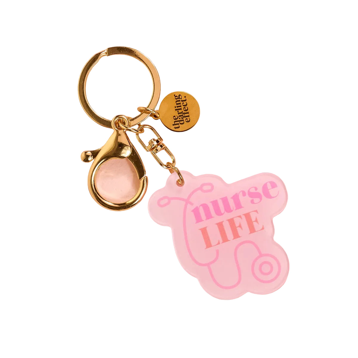 Gold keychain with 'nurse LIFE' pink tag on a pink background. Available at Be Charmed