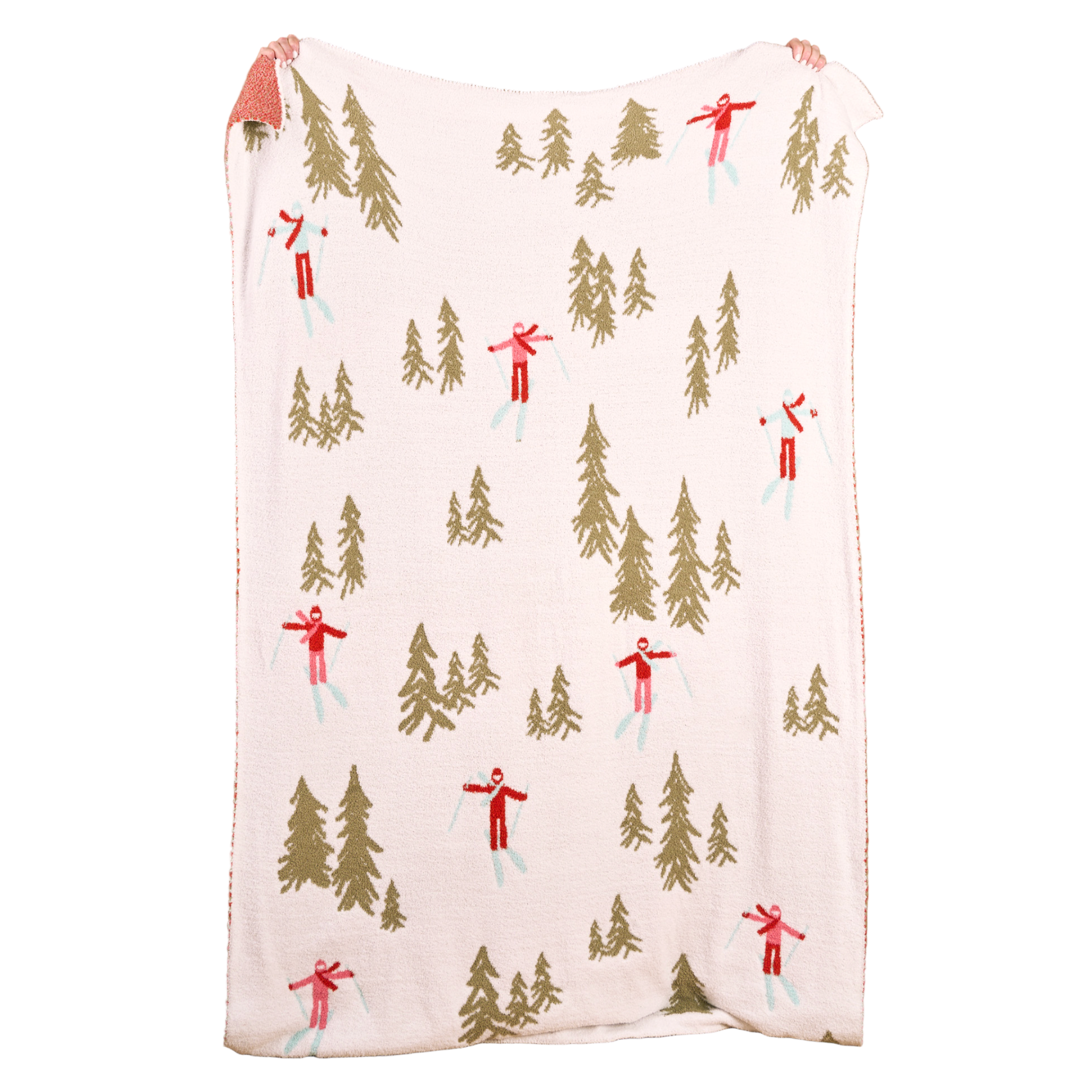 The Darling Effect throw blanket with winter scene pattern featuring trees and skiers on a white background. Available at Be Charmed. 