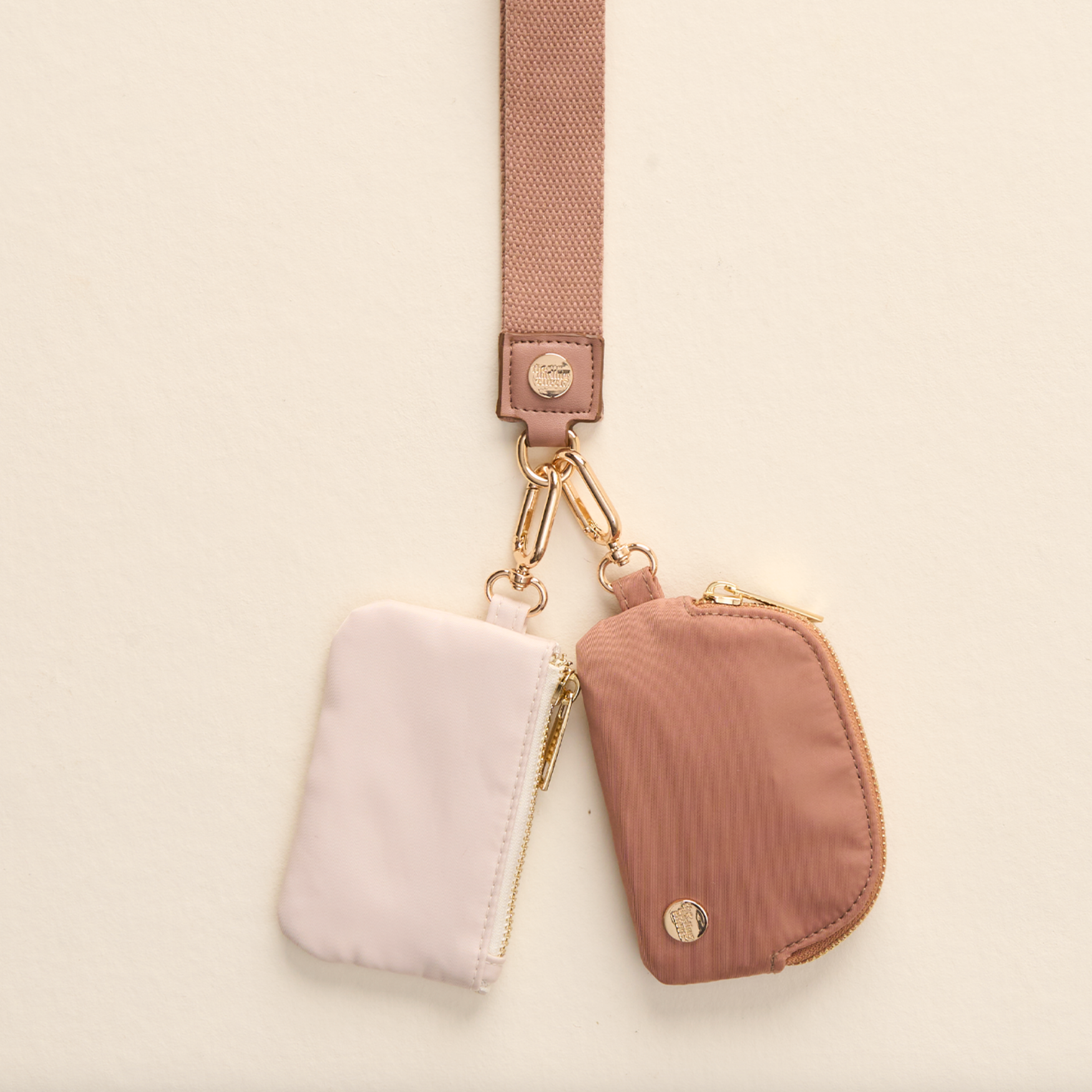 The Darling Effect Dynamic Duo Pouch Wristlet – two coordinating brown and pink pouches with wrist strap. Available at Be Charmed.